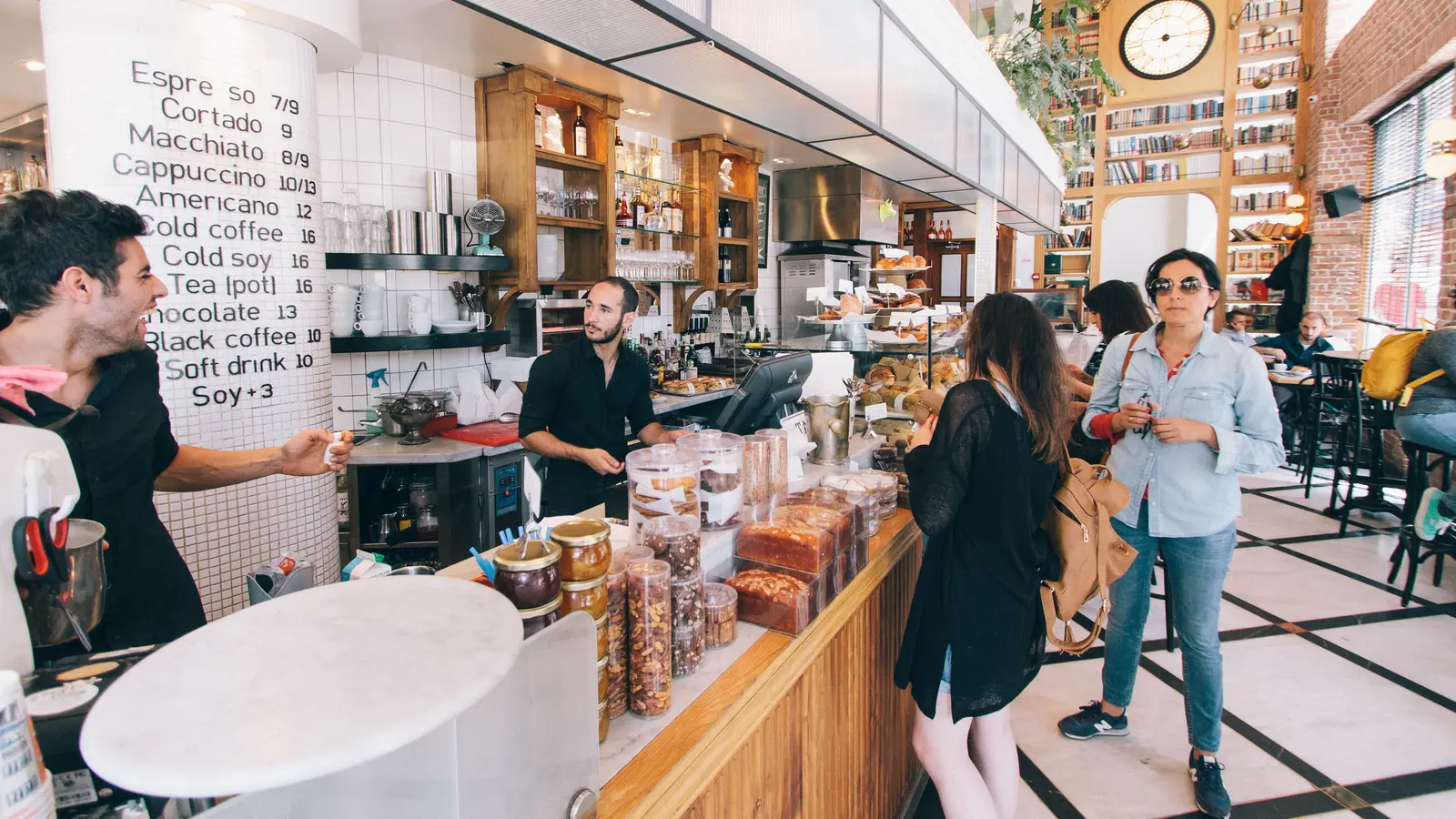 Café animé où des clients passent commande au comptoir