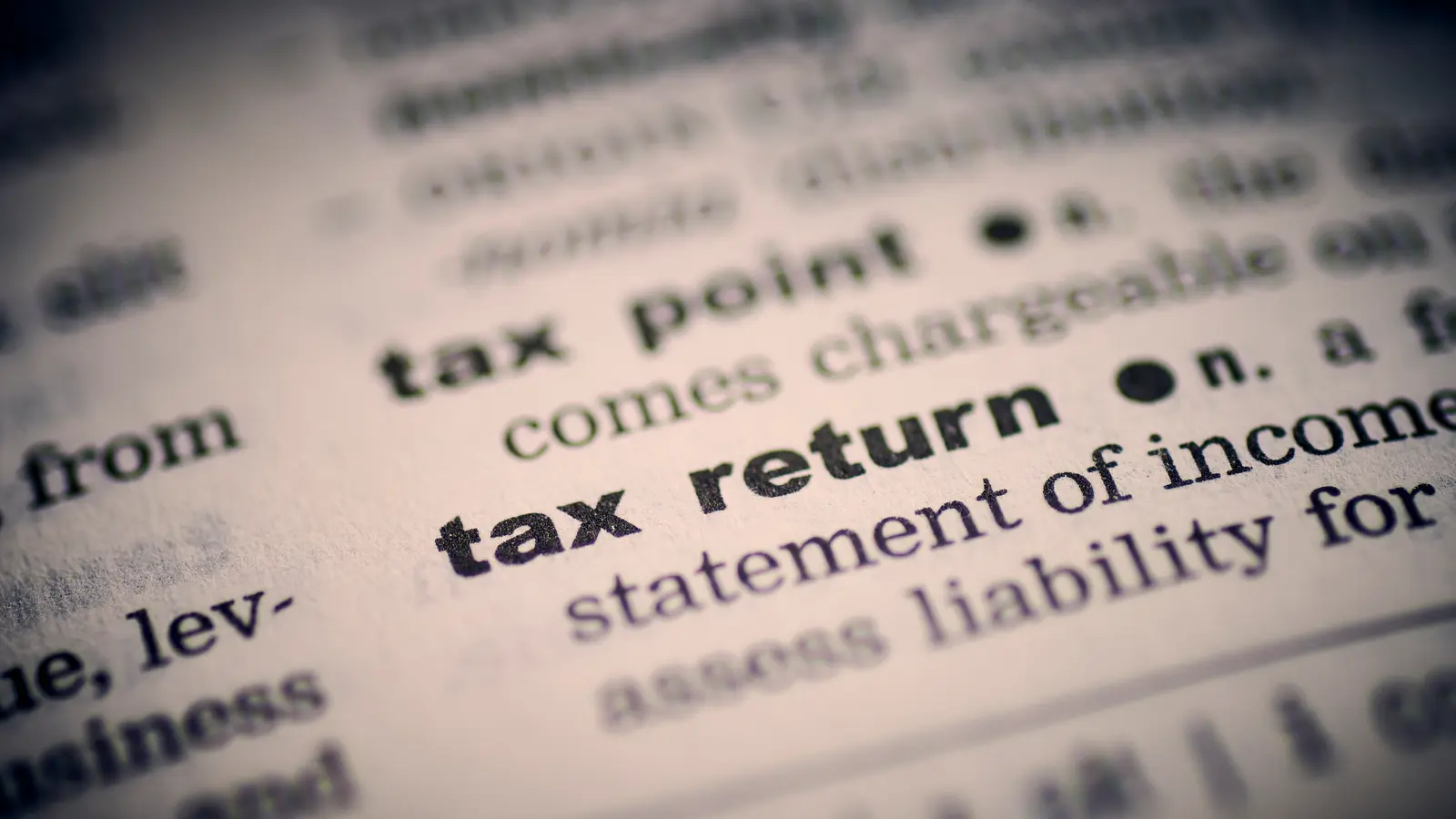 Page de dictionnaire en anglais montrant les mots « tax point » et « tax return »